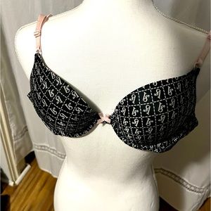 Victoria’s Secret black bra white VS symbols